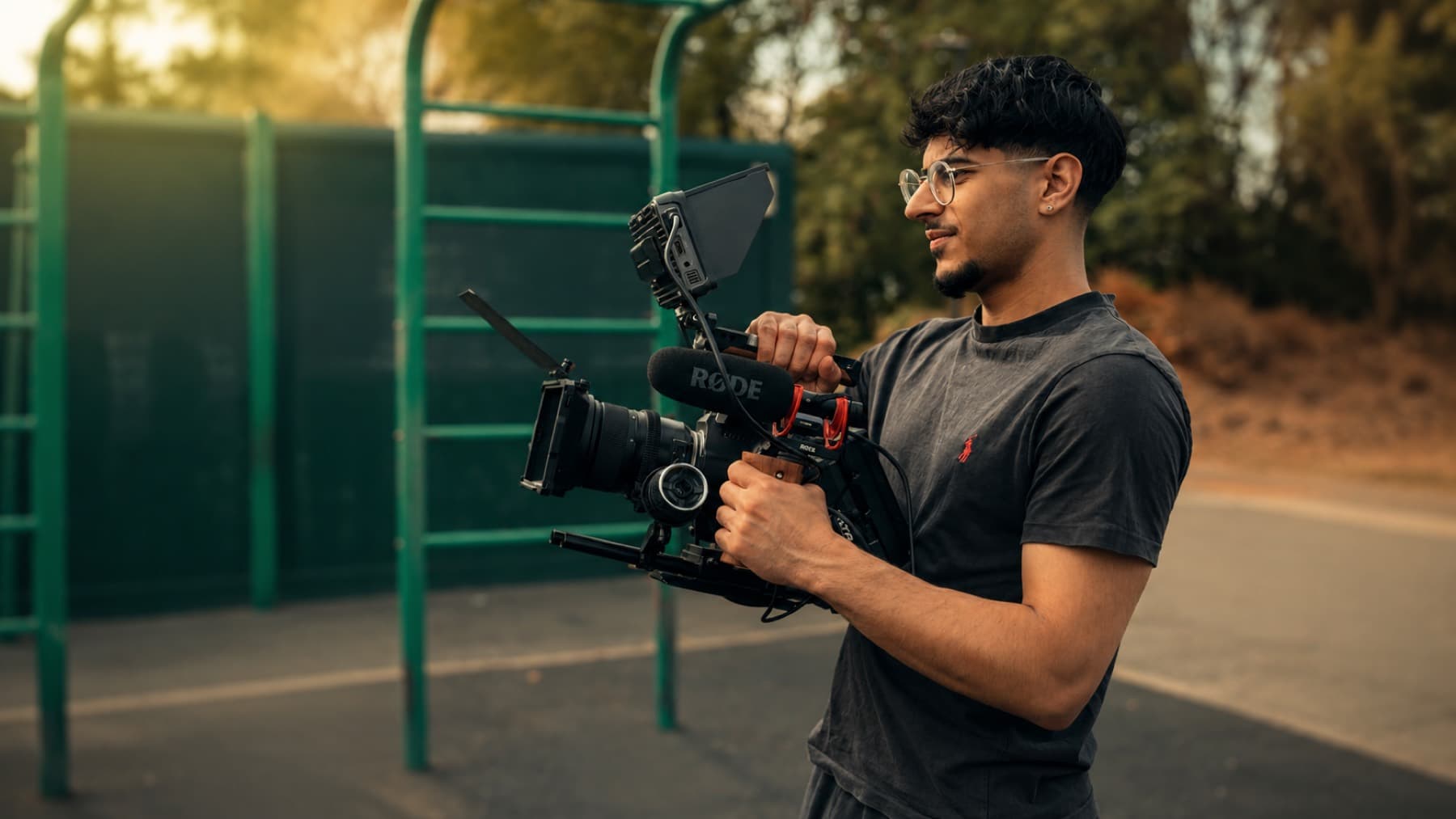 Qasim filming with a cinema camera rig